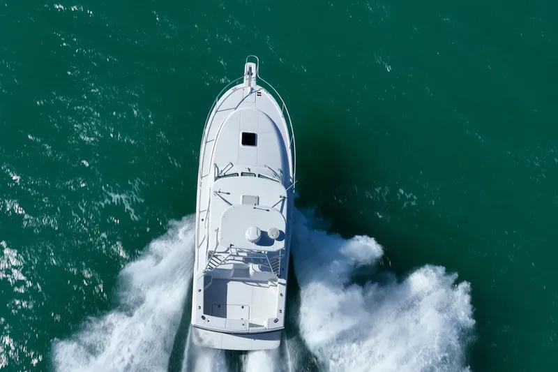 Slide: The Image of Aerial view of 2004 Luhrs 32 Open boat cruising on turquoise water. - 67