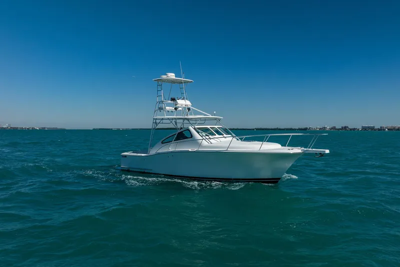 Slide: The Image of 2004 Luhrs 32 Open boat cruising on clear blue ocean waters. - 71