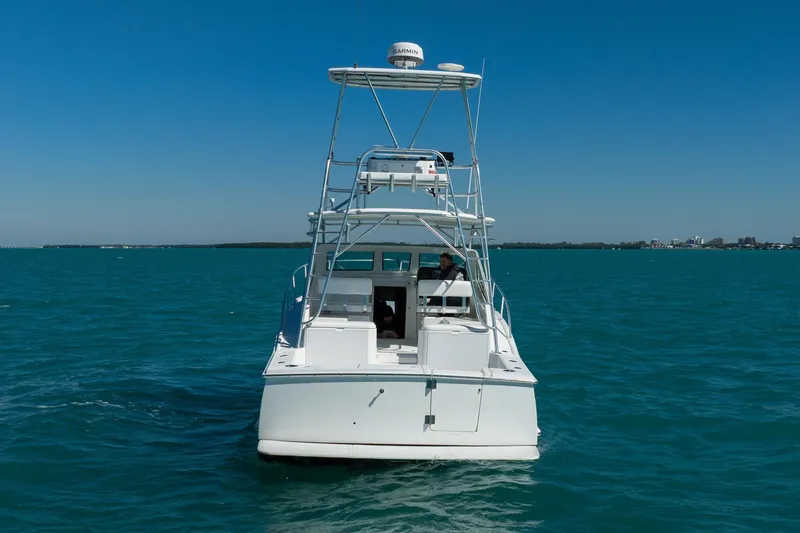 Slide: The Image of 2004 Luhrs 32 Open boat on clear blue water, rear view. - 75