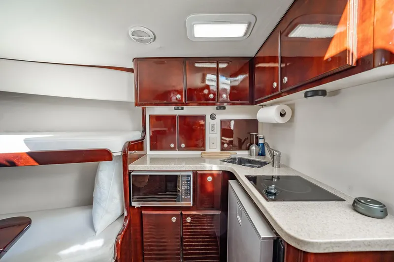 Slide: The Image of Luxurious 2004 Luhrs 32 Open yacht interior with modern kitchen and cozy sleeping area. - 83