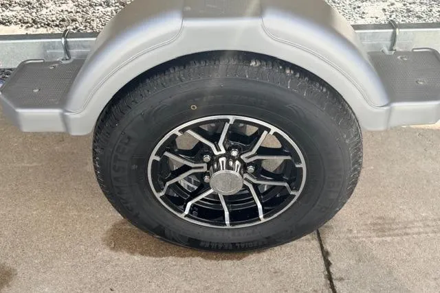 Slide: The Image of Trailer wheel of 2026 Crestliner 1760 Retriever Jon boat on concrete surface. - 12