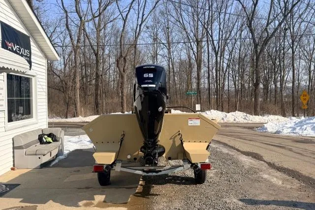 Slide: The Image of 2026 Crestliner 1760 Retriever Jon boat on trailer, parked near snowy roadside. - 3