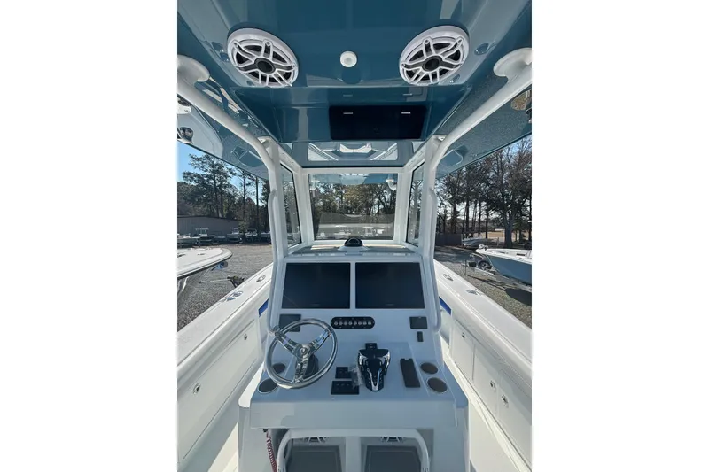 Slide: The Image of 2026 Yellowfin 36 Offshore boat cockpit with modern controls and steering wheel. - 13