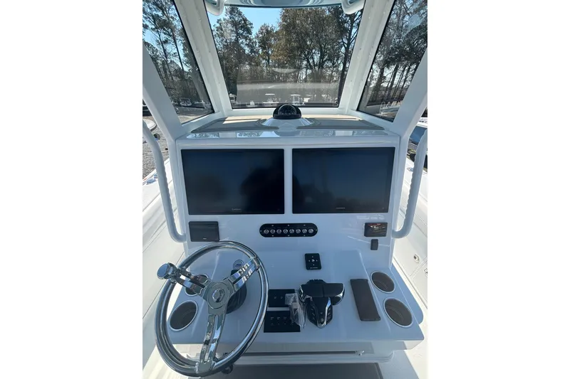 Slide: The Image of 2026 Yellowfin 36 Offshore boat console with dual screens and steering wheel. - 15