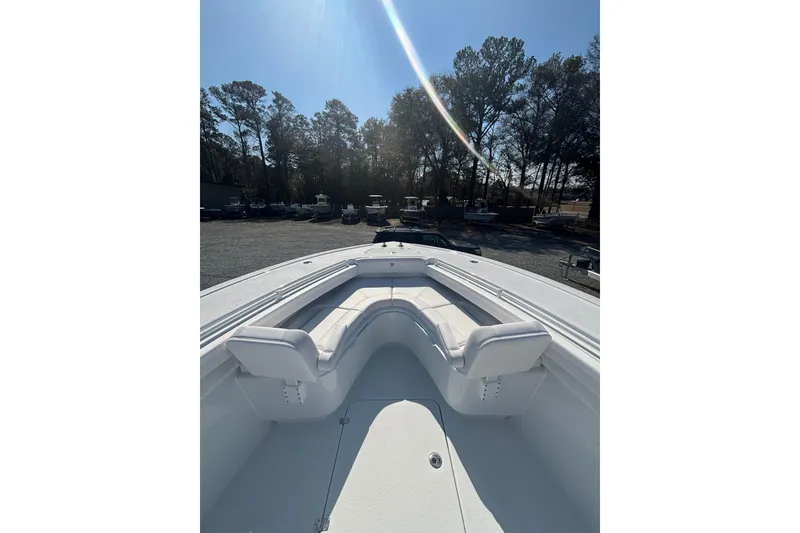 Slide: The Image of 2026 Yellowfin 36 Offshore boat with spacious seating, parked outdoors under clear sky. - 17