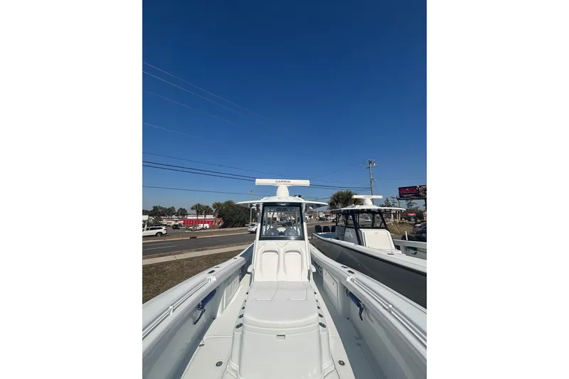 Slide: The Image of 2026 Yellowfin 36 Offshore boat displayed outdoors under clear blue sky. - 19
