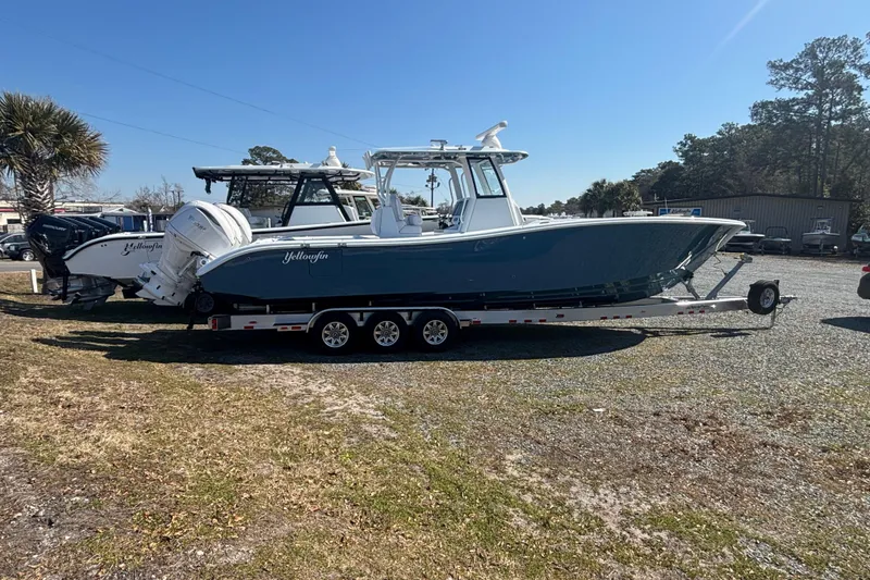 Slide: The Image of 2026 Yellowfin 36 Offshore boat on trailer, parked outdoors under clear sky. - 2