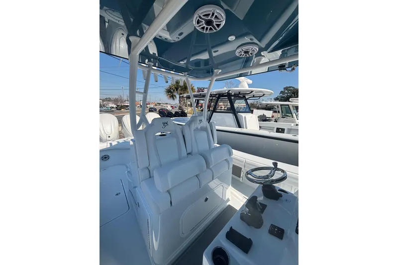 Slide: The Image of 2026 Yellowfin 36 Offshore boat interior with helm, seating, and speakers. - 20