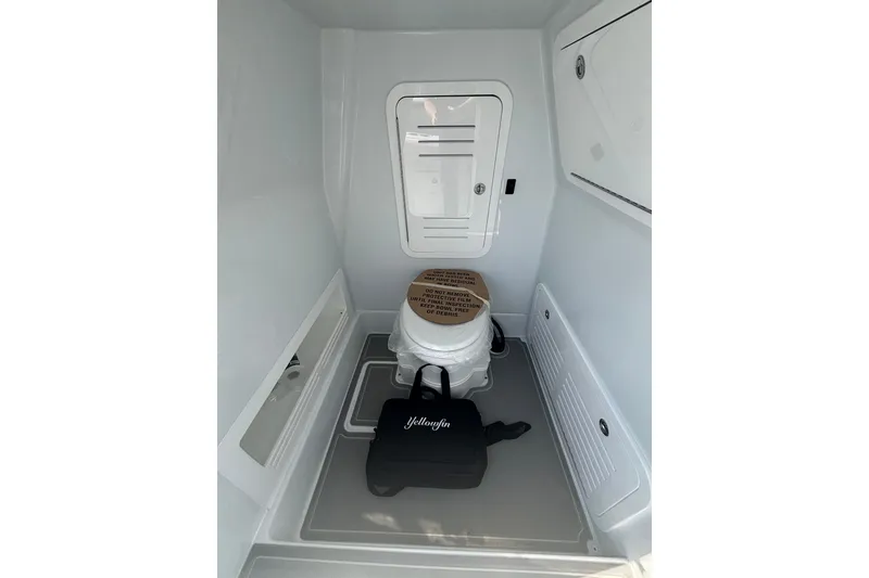 Slide: The Image of Interior of 2026 Yellowfin 36 Offshore boat, featuring a compact marine toilet. - 24