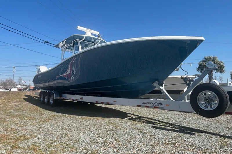 Slide: The Image of 2026 Yellowfin 36 Offshore boat on trailer under clear blue sky. - 6
