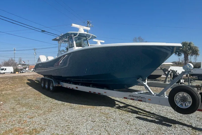 Slide: The Image of 2026 Yellowfin 36 Offshore boat on trailer, parked outdoors under clear blue sky. - 7