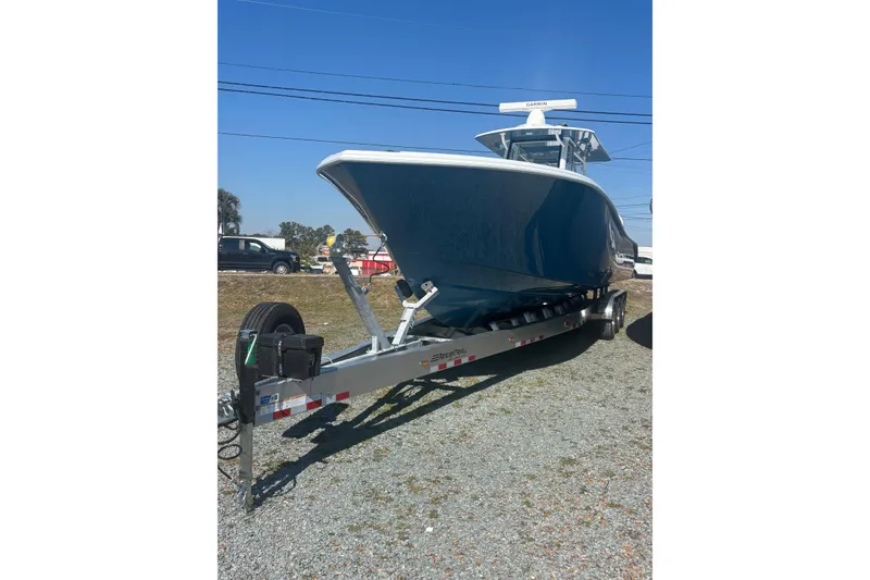 Slide: The Image of 2026 Yellowfin 36 Offshore boat on trailer, parked outdoors under clear blue sky. - 8