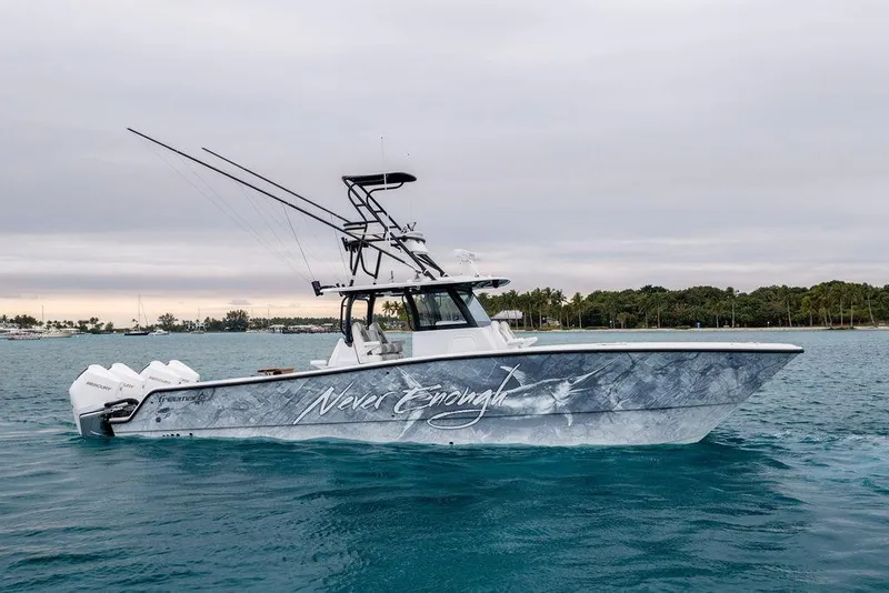 The Image of Freeman 38 boat, 2025 model, on water with custom graphics and multiple outboard engines. - 1