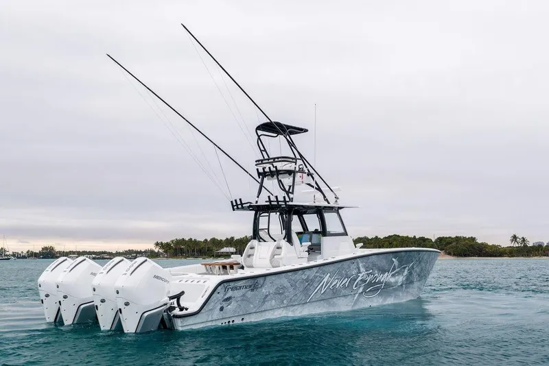 Slide: The Image of 2025 Freeman 38 boat with multiple engines on calm water, overcast sky. - 2