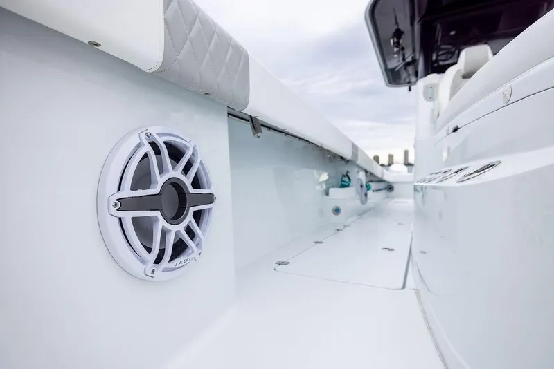 Slide: The Image of 2025 Freeman 38 boat interior with speaker and cushioned seating. - 20