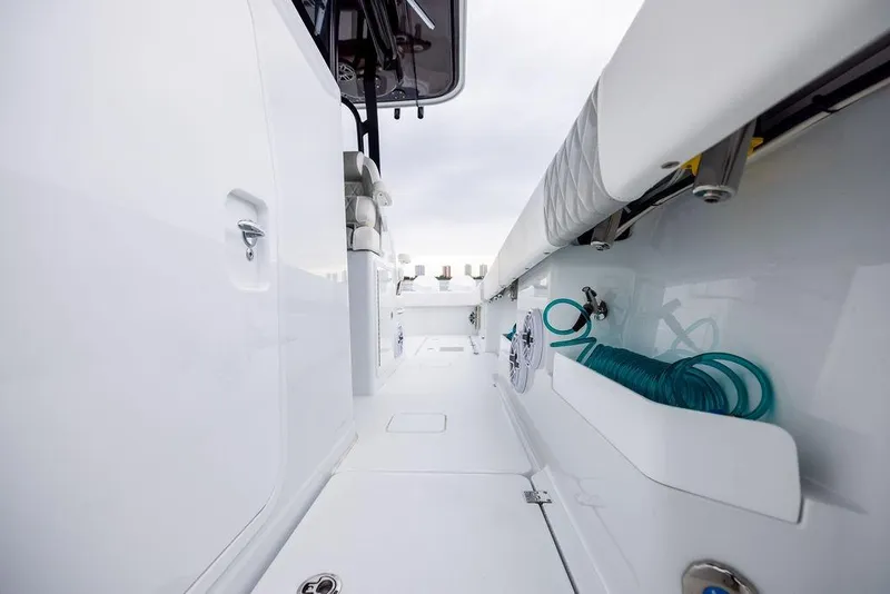 Slide: The Image of 2025 Freeman 38 boat deck with storage compartments and coiled hose. - 22