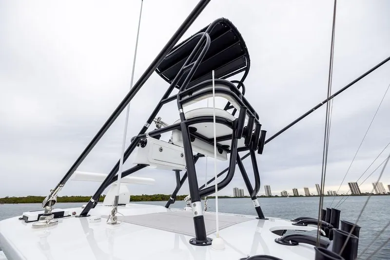 Slide: The Image of 2025 Freeman 38 boat with elevated seating, sleek design, and city skyline in the background. - 26