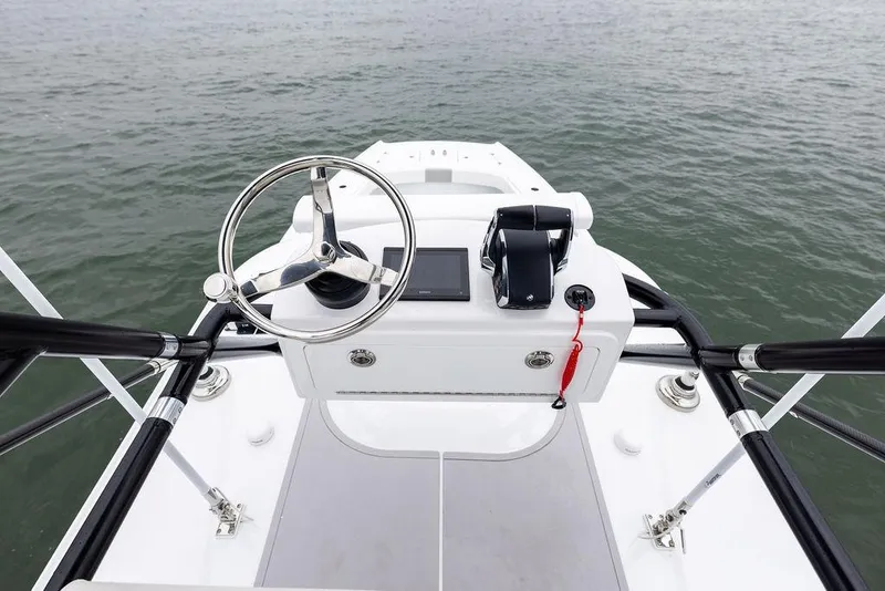 Slide: The Image of Steering console of 2025 Freeman 38 boat on calm water. - 29