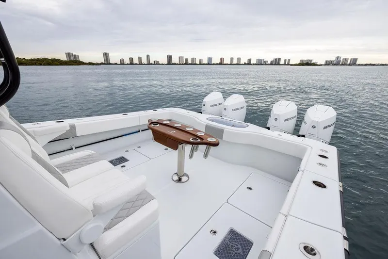 Slide: The Image of Luxury Freeman 38 boat, 2025 model, with spacious deck and multiple outboard engines on calm water. - 30