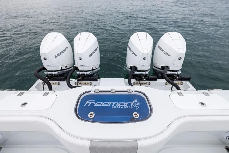 Slide: The Image of Freeman 38 boat with four Mercury outboard engines, 2025 model, on open water. - 34