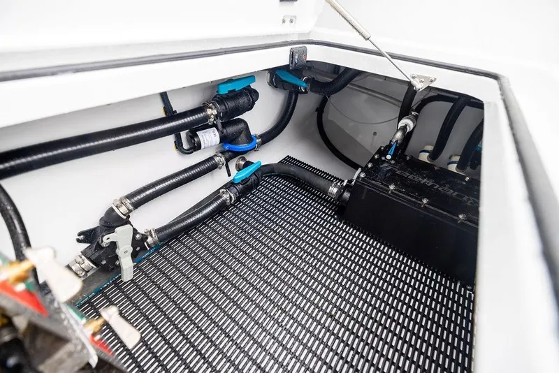 Slide: The Image of Engine compartment of 2025 Freeman 38 boat with visible hoses and components. - 38