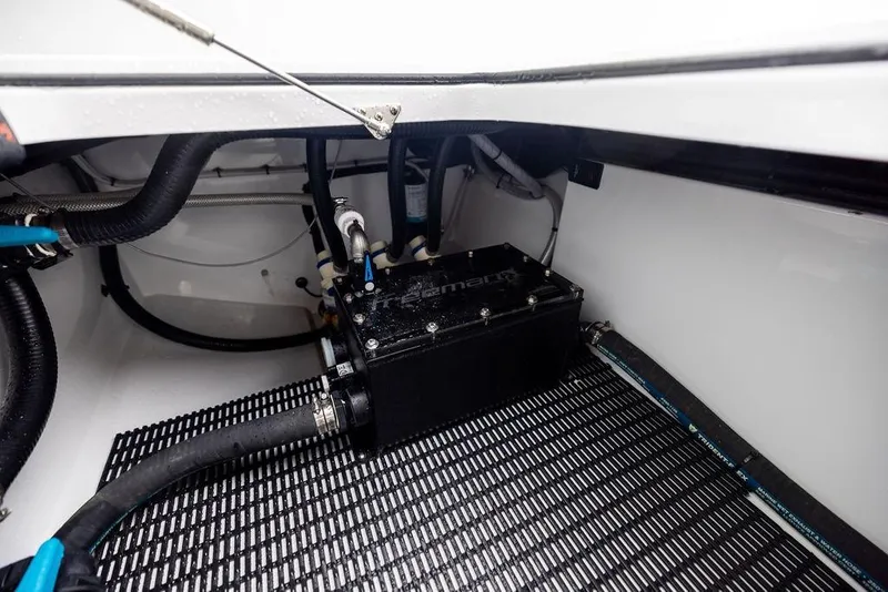Slide: The Image of Engine compartment of 2025 Freeman 38 boat with visible hoses and components. - 40