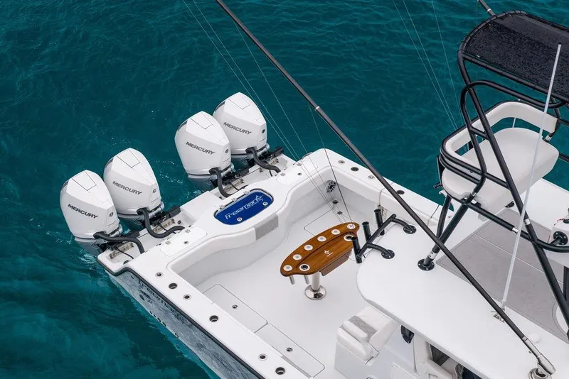 Slide: The Image of Freeman 38 boat, 2025 model, with four Mercury outboard engines on blue water. - 7
