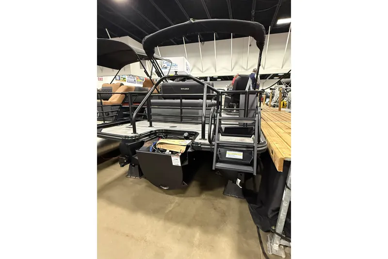 Slide: The Image of 2026 Sylvan Mirage X X3 CLZ DH pontoon boat displayed indoors, rear view. - 3