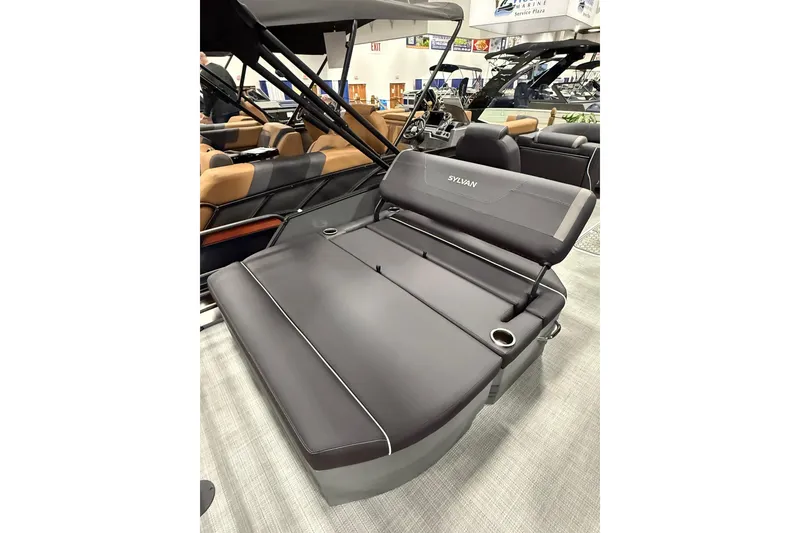 Slide: The Image of 2026 Sylvan Mirage X X3 CLZ DH boat interior with luxurious seating and cup holders. - 5