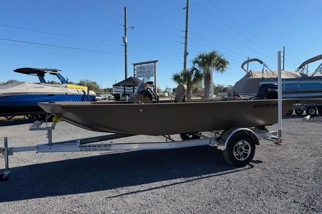 The Image of 2026 Smoker Craft Pro Sportsman 1660 boat on trailer in outdoor lot. - 1