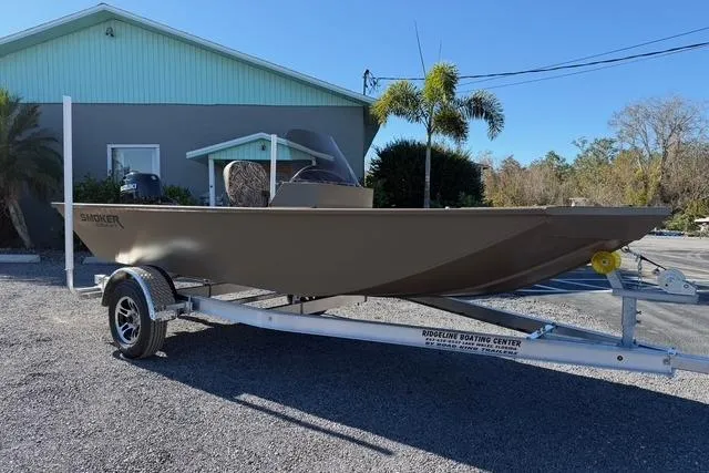 Slide: The Image of 2026 Smoker Craft Pro Sportsman 1660 boat on trailer, parked outdoors. - 3