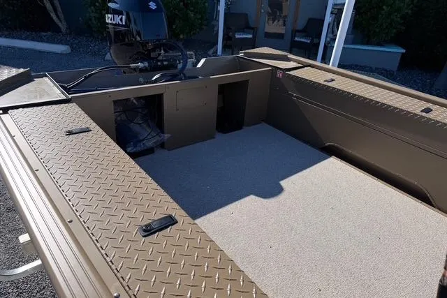 Slide: The Image of 2026 Smoker Craft Pro Sportsman 1660 boat interior with Suzuki engine, featuring spacious deck. - 6