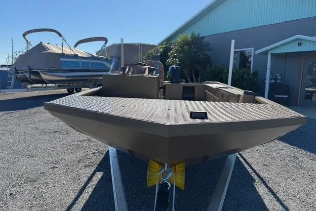 Slide: The Image of 2026 Smoker Craft Pro Sportsman 1660 boat displayed outdoors on a trailer. - 8