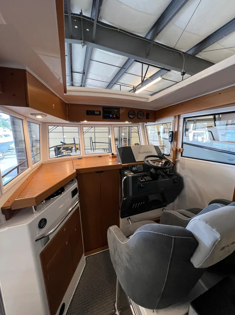 Slide: The Image of 2024 Sargo 28 boat interior with modern helm and seating. - 12