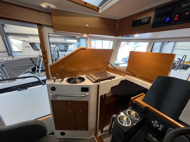 Slide: The Image of Interior of 2024 Sargo 28 boat with modern kitchen and control panel. - 17