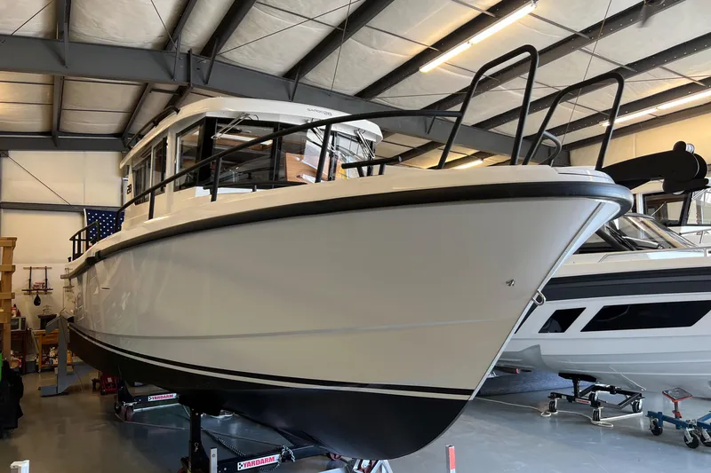 Slide: The Image of 2024 Sargo 28 boat in a warehouse, side view. - 2