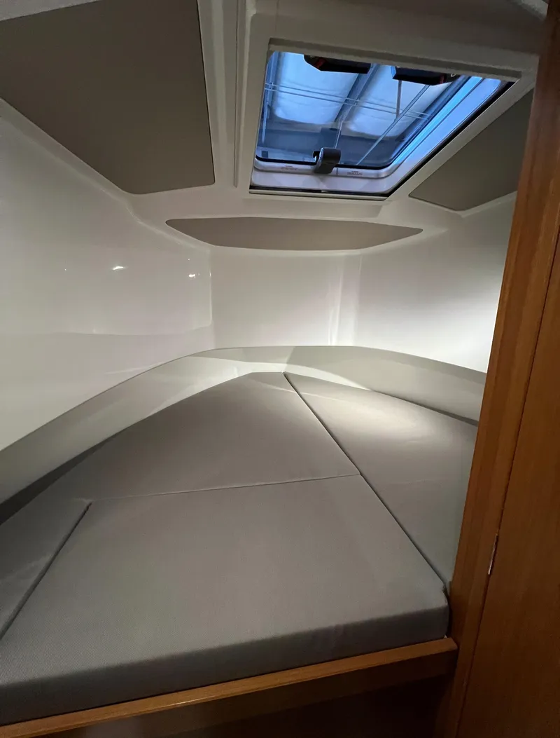 Slide: The Image of 2024 Sargo 28 cabin interior with skylight and cushioned bed. - 20
