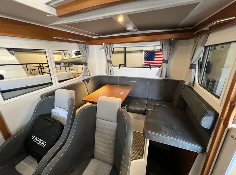 Slide: The Image of Interior of 2024 Sargo 28 boat with seating area and table. - 24