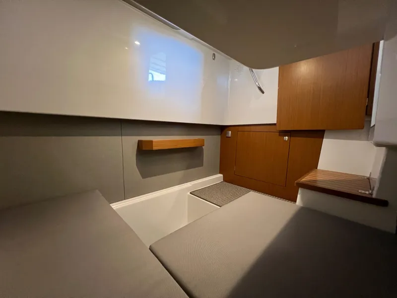 Slide: The Image of Interior cabin of 2024 Sargo 28 boat with modern design and wooden accents. - 26