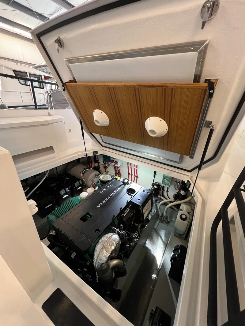Slide: The Image of Engine compartment of a 2024 Sargo 28 boat with open hatch. - 28