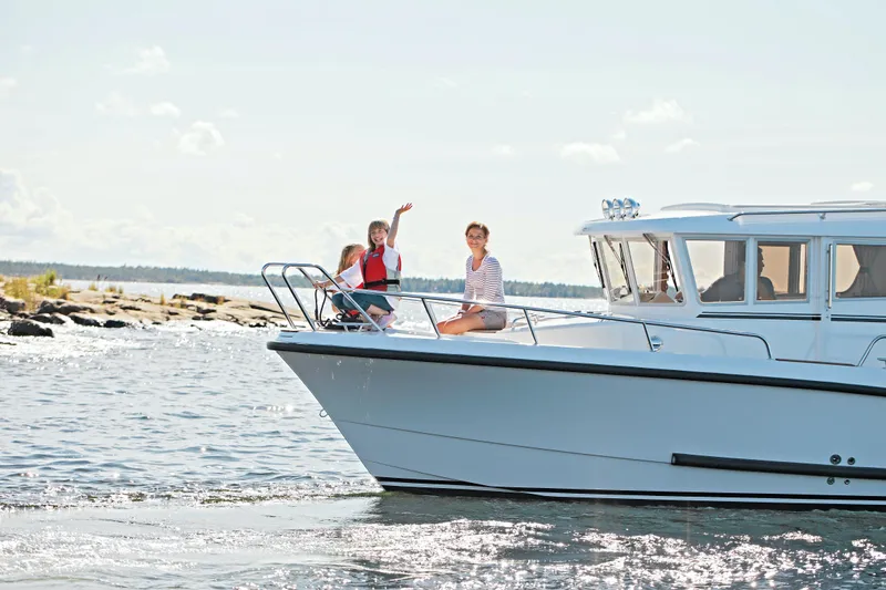 Slide: The Image of 2024 Sargo 28 boat with people enjoying a sunny day on the water. - 33
