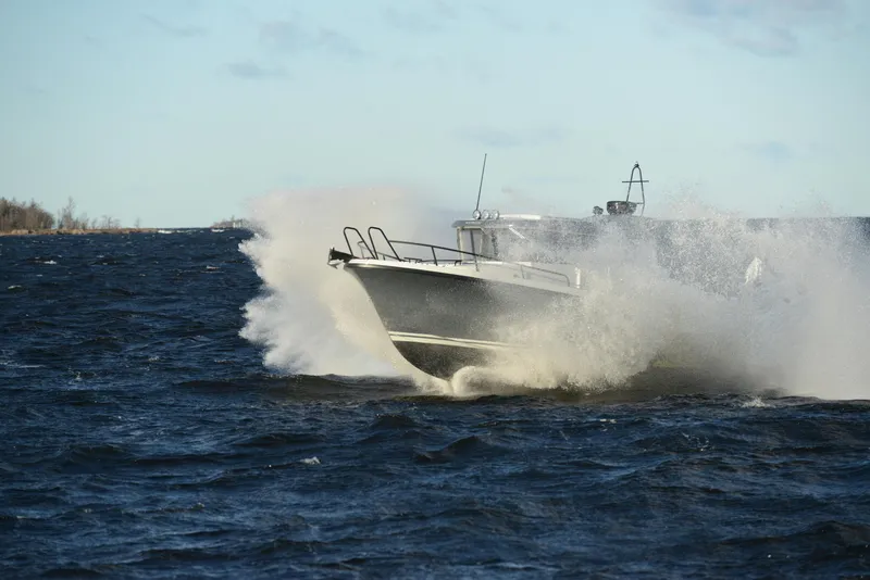 Slide: The Image of 2024 Sargo 28 boat navigating rough waters with splashing waves. - 34