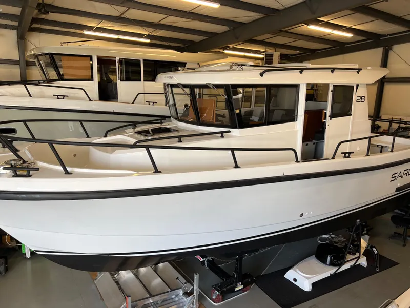 Slide: The Image of 2024 Sargo 28 boat in showroom, white exterior, side view. - 8