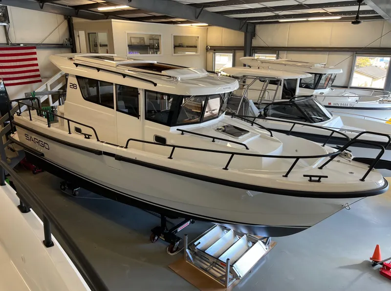 Slide: The Image of 2024 Sargo 28 boat displayed in a showroom. - 9