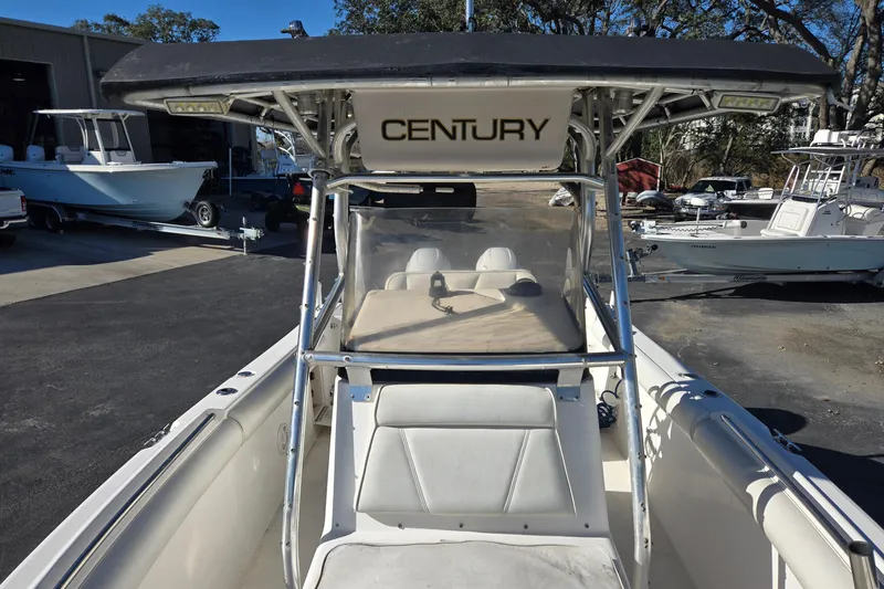 Slide: The Image of 2006 Century 2400 Center Console boat with T-top in a marina setting. - 10