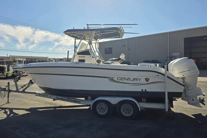 Slide: The Image of 2006 Century 2400 Center Console boat on trailer, parked outdoors. - 6