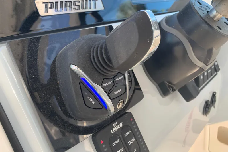 Slide: The Image of Joystick control on 2023 Pursuit DC 266 Dual Console boat dashboard. - 12