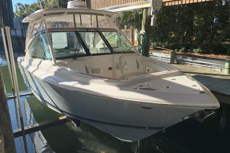 Slide: The Image of 2023 Pursuit DC 266 Dual Console boat docked in a marina. - 19