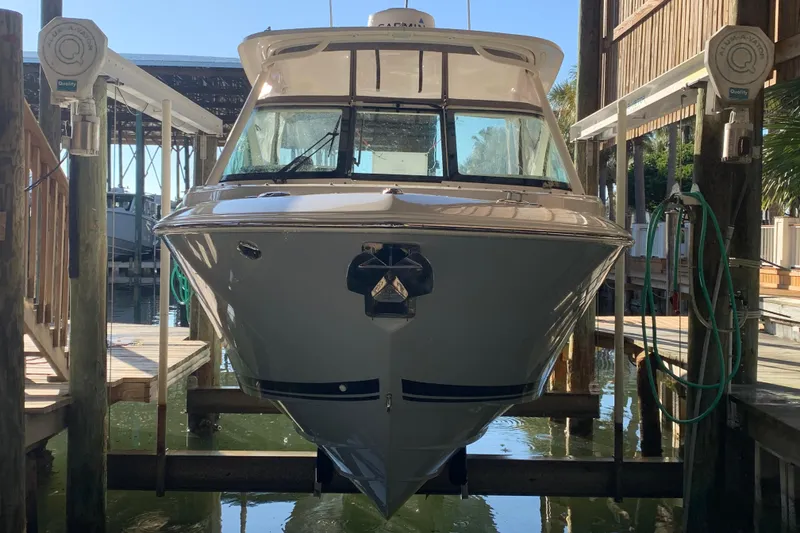 Slide: The Image of 2023 Pursuit DC 266 Dual Console boat docked in marina. - 3