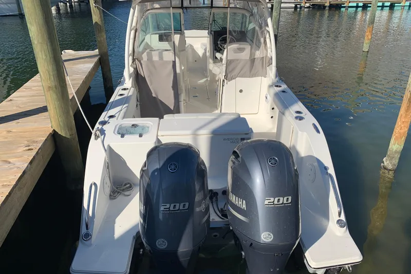 Slide: The Image of 2023 Pursuit DC 266 Dual Console boat with twin Yamaha 200 engines docked. - 5